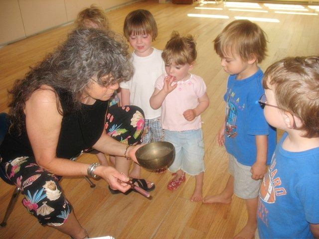 Denya engaging children in a music program